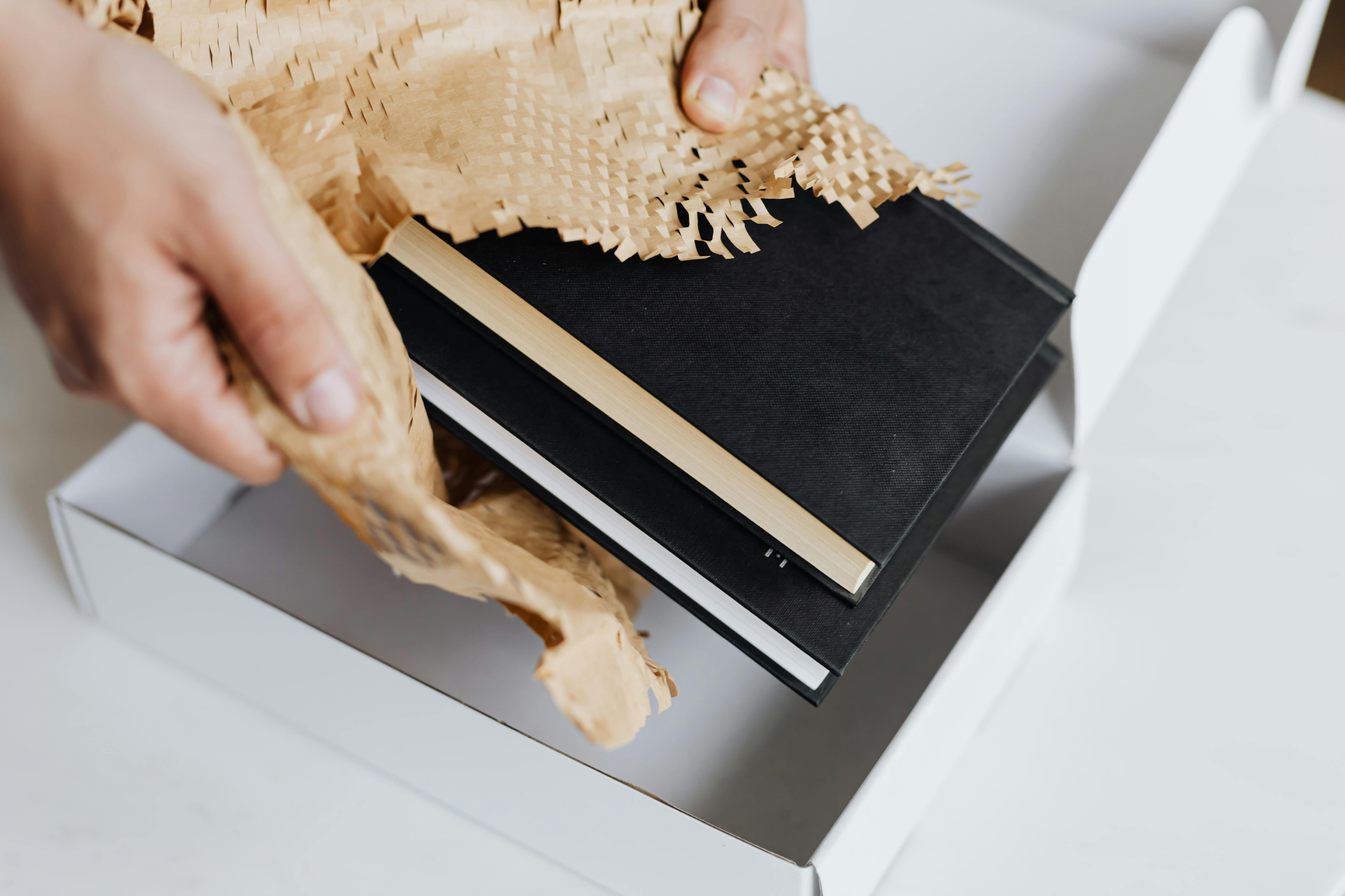 Man Wrapping Black Notebook
